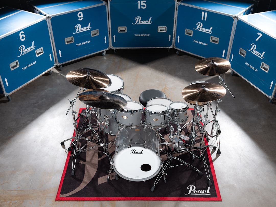 A drum set sits surrounded by blue cases.