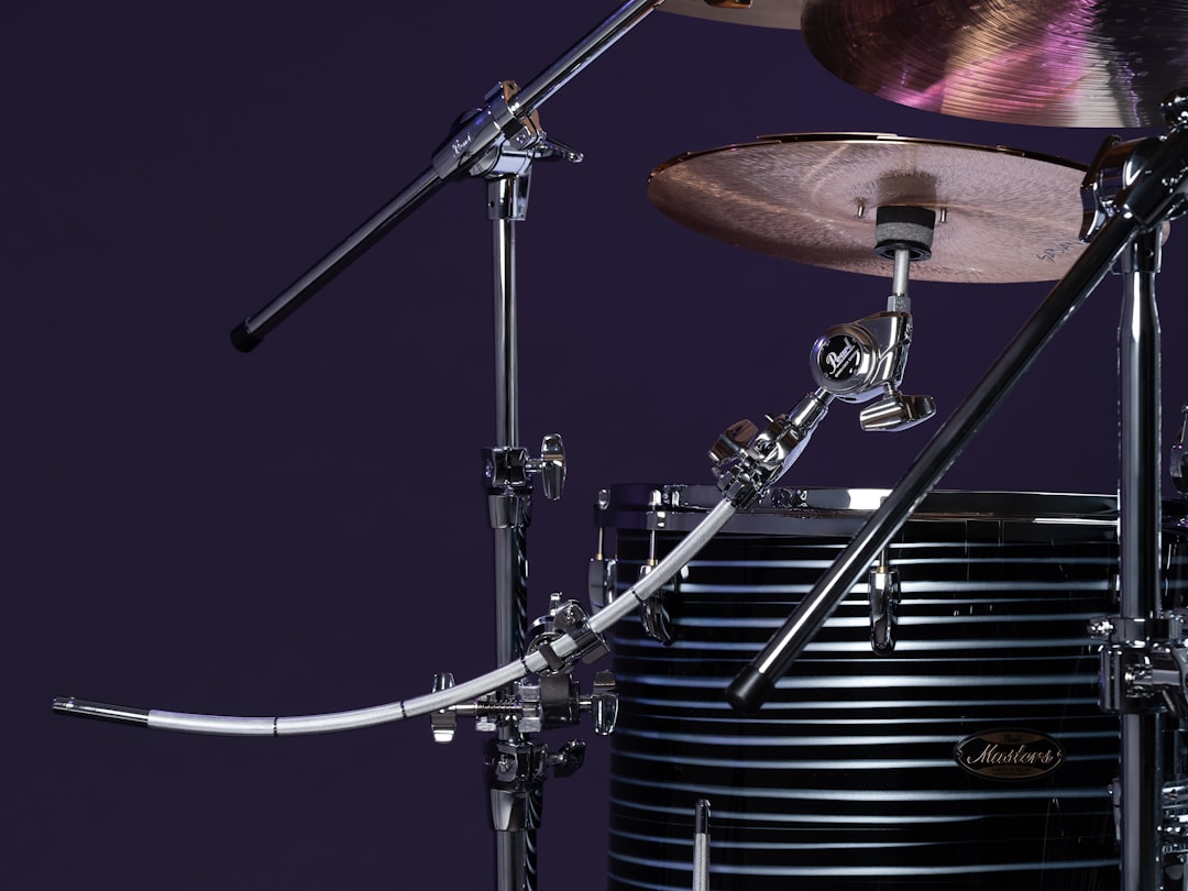 Drumstick hitting a cymbal on a drum set