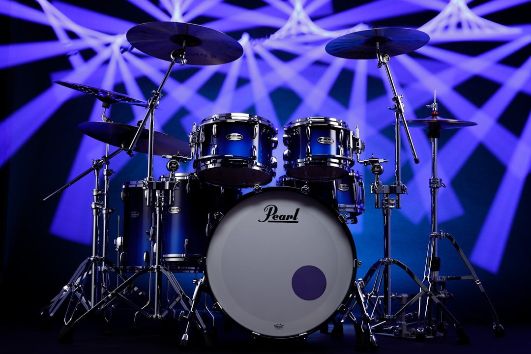 A set of drums sits in front of a stage